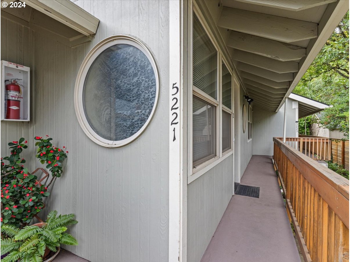 5221 Southwest View Point Terrace, Unit 2 Portland, OR 97239 - Photo 4 of 30 a view of a hallway with wooden floor and a potted plant