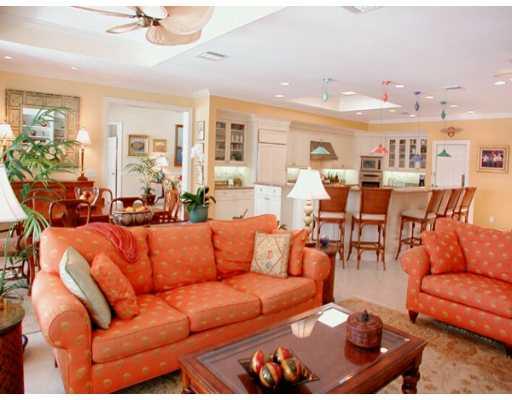 61 South River Road Stuart, FL 34996 - Photo 3 of 8 a living room with furniture kitchen view and a chandelier