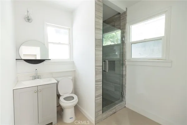 a bathroom with a toilet a sink and a window