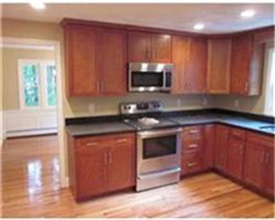 4 Scott Road Harvard, MA 01451 - Photo 5 of 12 a kitchen with stainless steel appliances granite countertop a stove a microwave and a sink