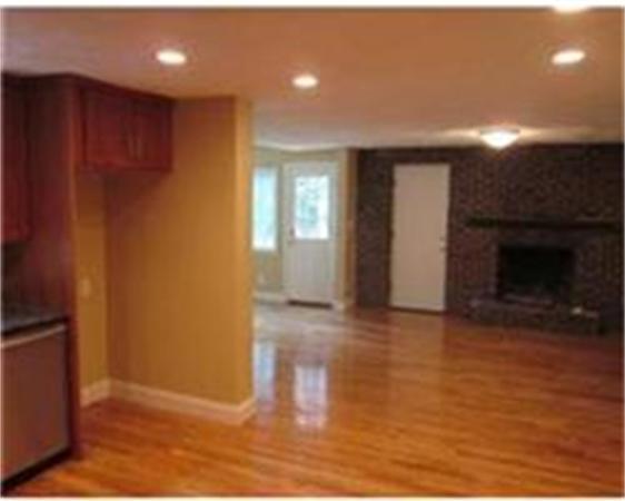 4 Scott Road Harvard, MA 01451 - Photo 9 of 12 an empty room with wooden floor and fireplace