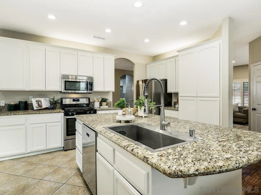 16304 Dartolo Road Ramona, CA 92065 - Photo 9 of 36 a kitchen with stainless steel appliances granite countertop a sink stove and refrigerator