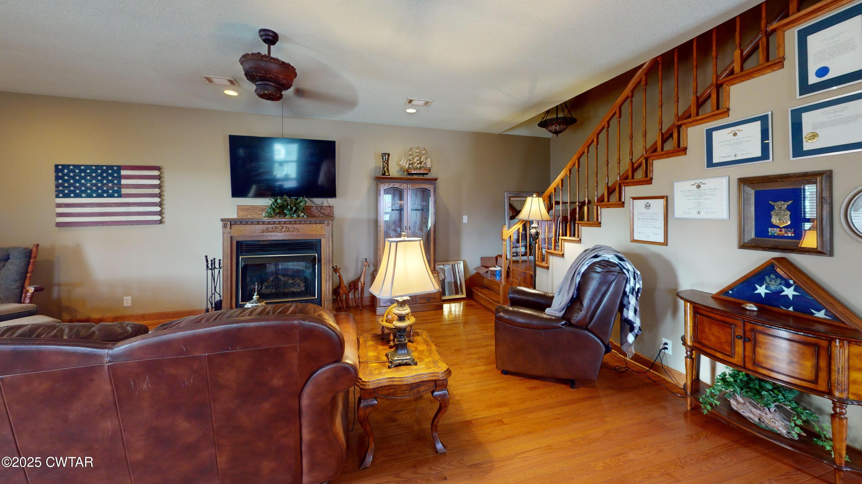 1268 Lightfoot Luckett Road Ripley, TN 38063 - Photo 6 of 40 a living room with furniture a flat screen tv and a fireplace