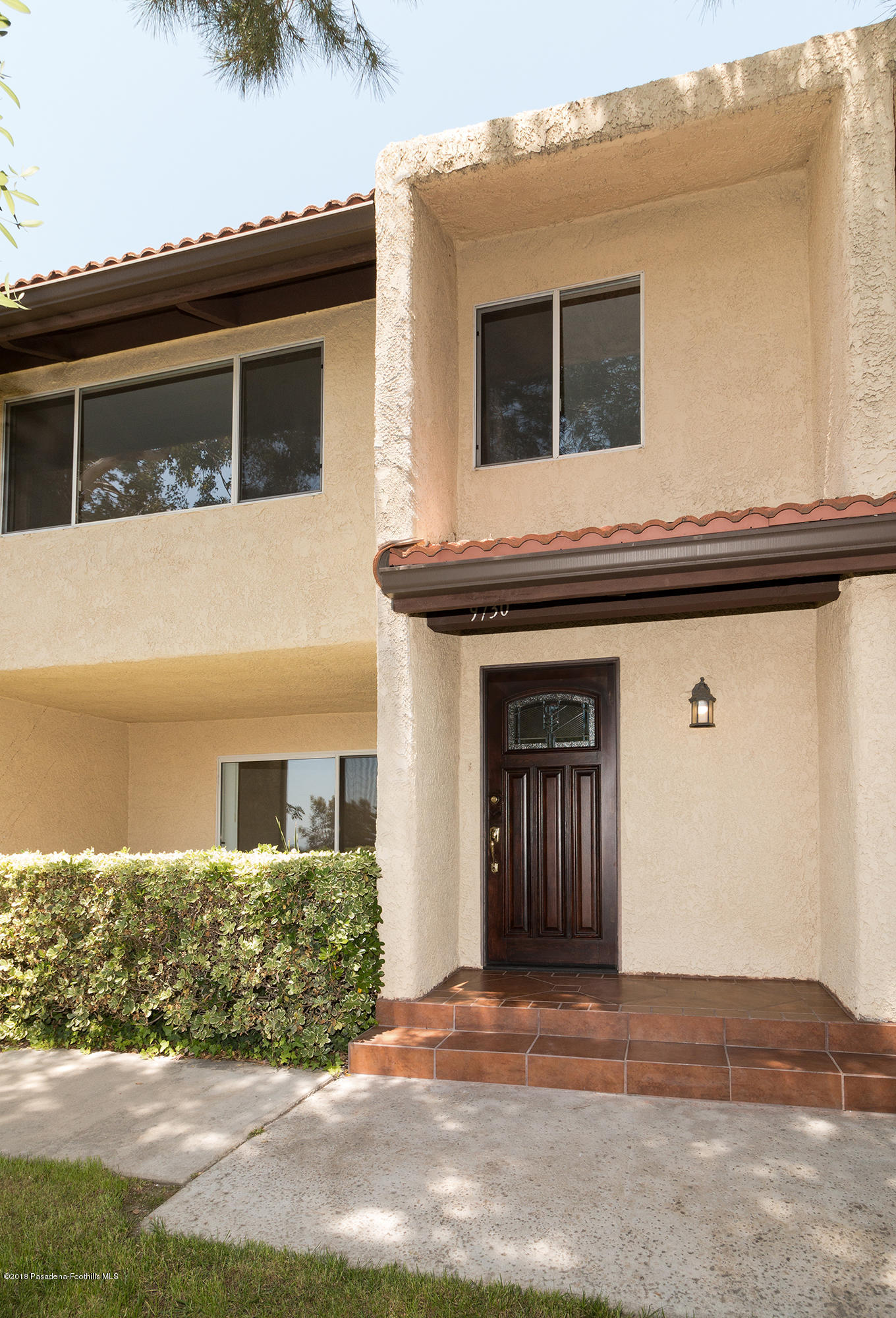 9730 Vía Roma Burbank, CA 91504 - Photo 2 of 24 a front view of a house with a yard