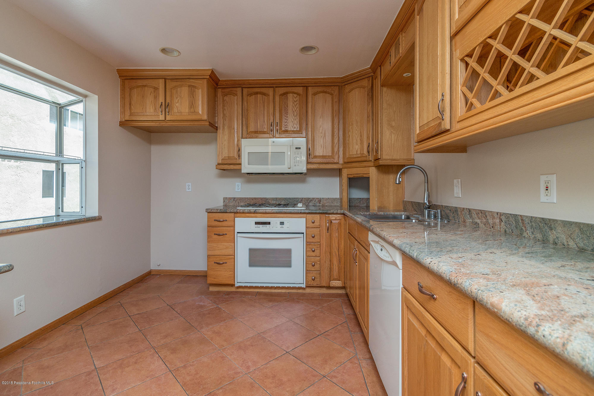 9730 Vía Roma Burbank, CA 91504 - Photo 11 of 24 a kitchen with stainless steel appliances granite countertop a stove and a sink