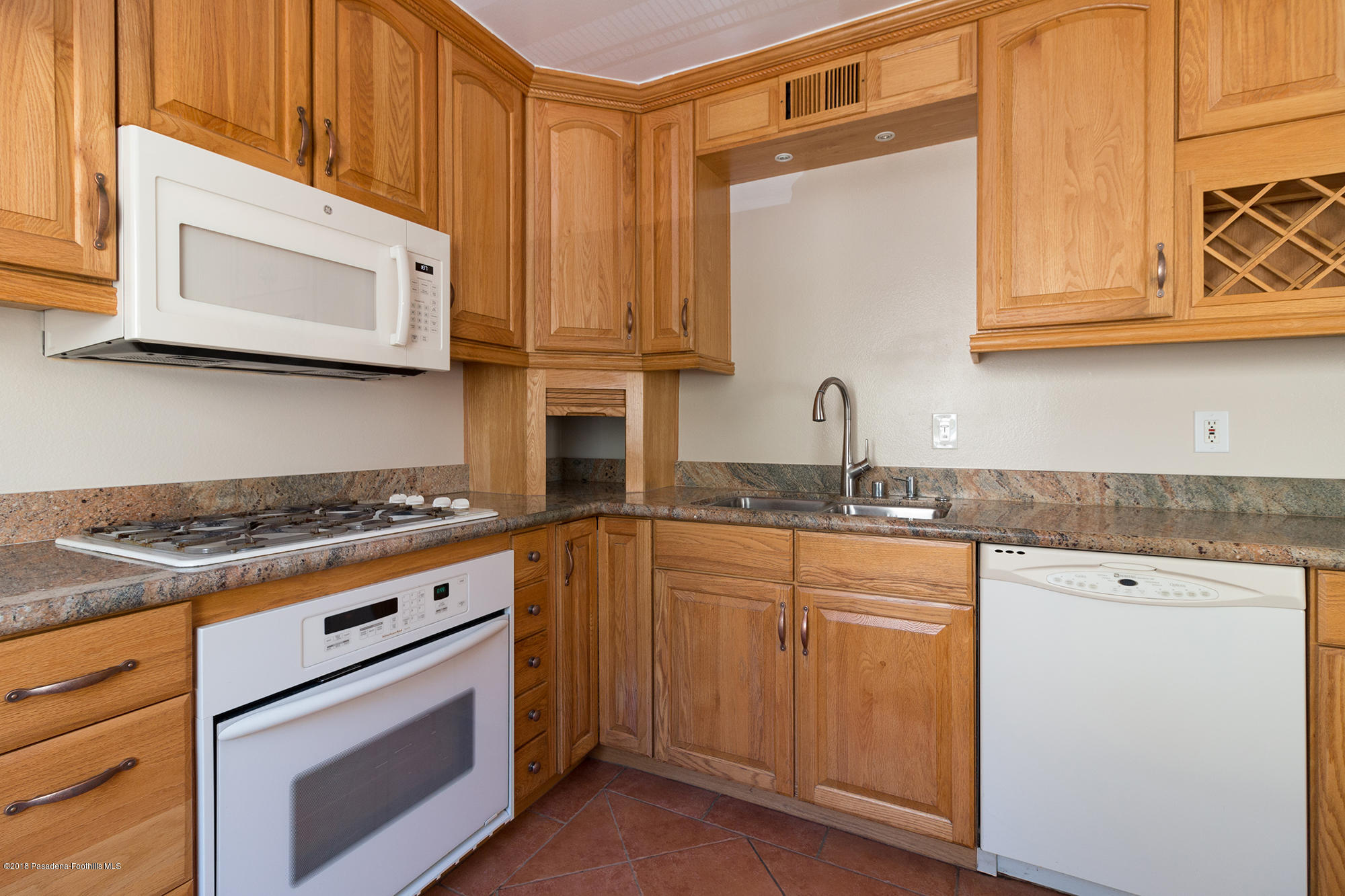 9730 Vía Roma Burbank, CA 91504 - Photo 12 of 24 a kitchen with stainless steel appliances granite countertop a stove a sink and a microwave