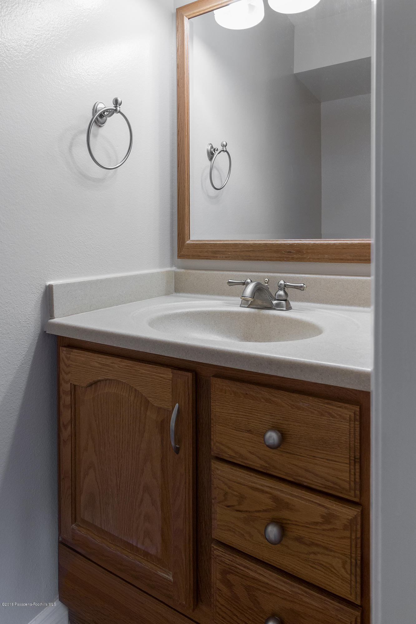 9730 Vía Roma Burbank, CA 91504 - Photo 14 of 24 a bathroom with a sink vanity and a mirror