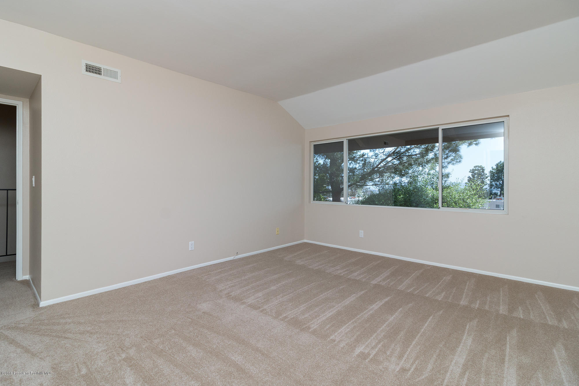 9730 Vía Roma Burbank, CA 91504 - Photo 17 of 24 an empty room with wooden floor and windows