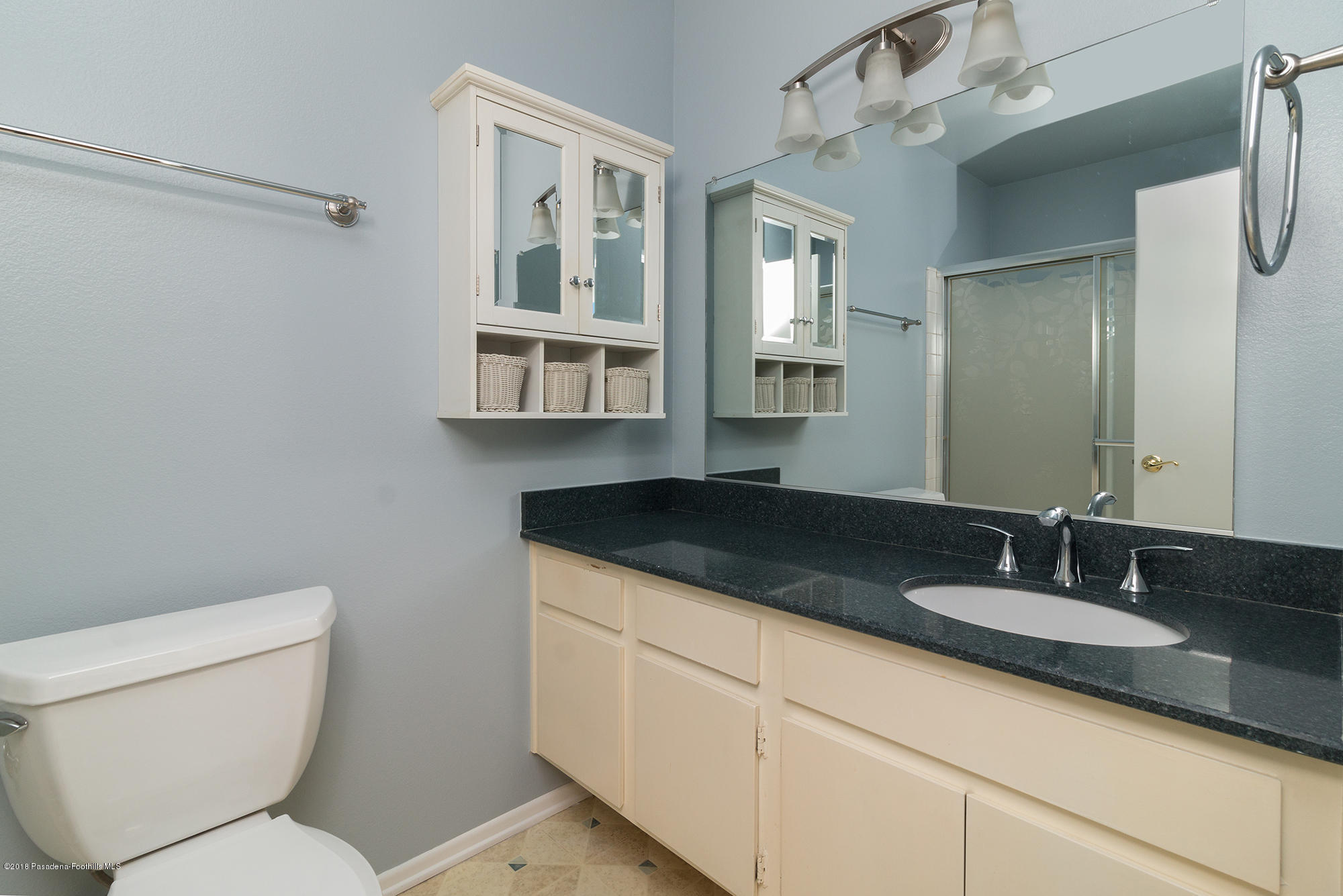 9730 Vía Roma Burbank, CA 91504 - Photo 19 of 24 a bathroom with a granite countertop sink mirror vanity and toilet