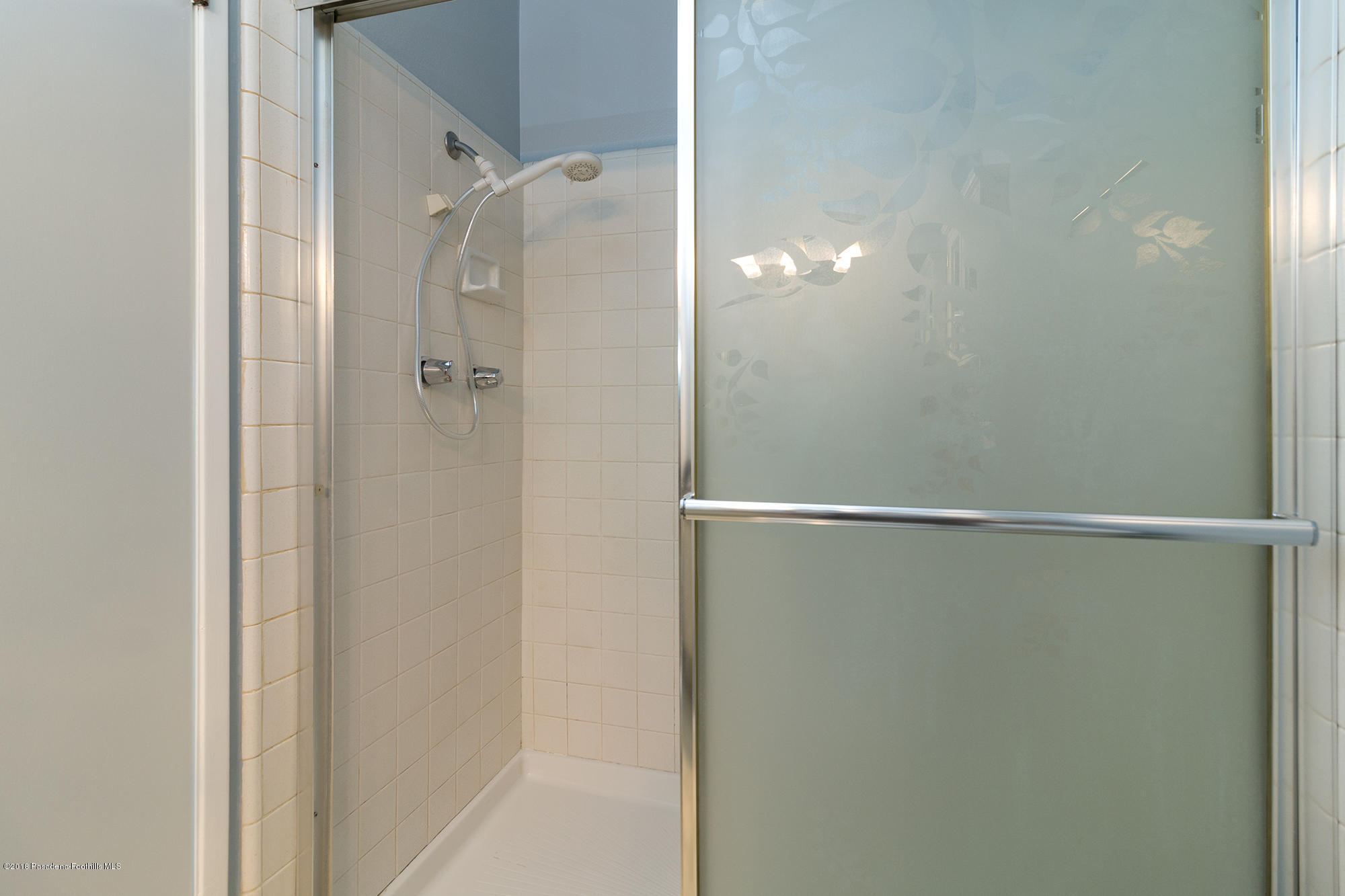 9730 Vía Roma Burbank, CA 91504 - Photo 20 of 24 a bathroom with a glass shower door