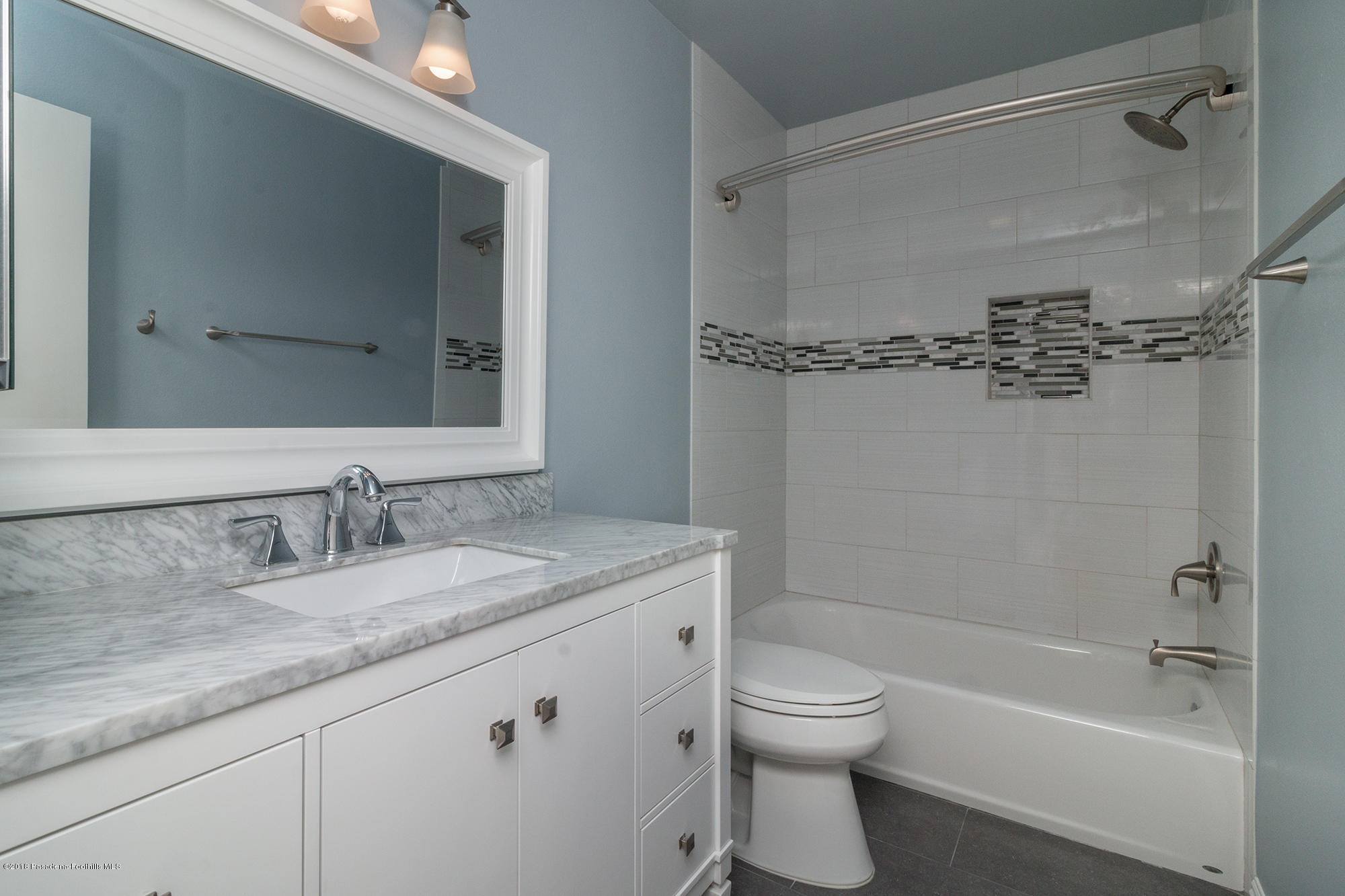 9730 Vía Roma Burbank, CA 91504 - Photo 21 of 24 a bathroom with a granite countertop sink a toilet and shower