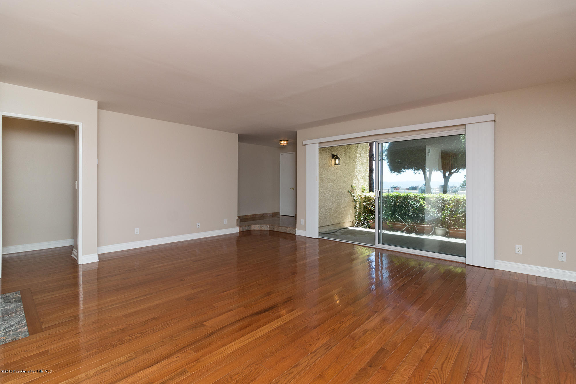9730 Vía Roma Burbank, CA 91504 - Photo 7 of 24 wooden floor in an empty room with a window