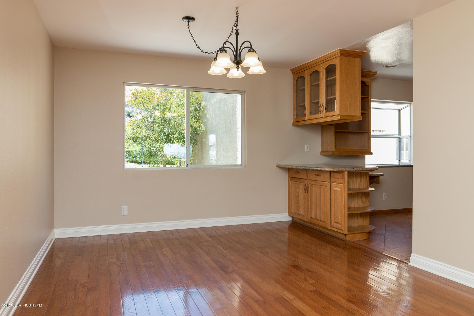 9730 Vía Roma Burbank, CA 91504 - Photo 9 of 24 a view of a room with wooden floor and a window