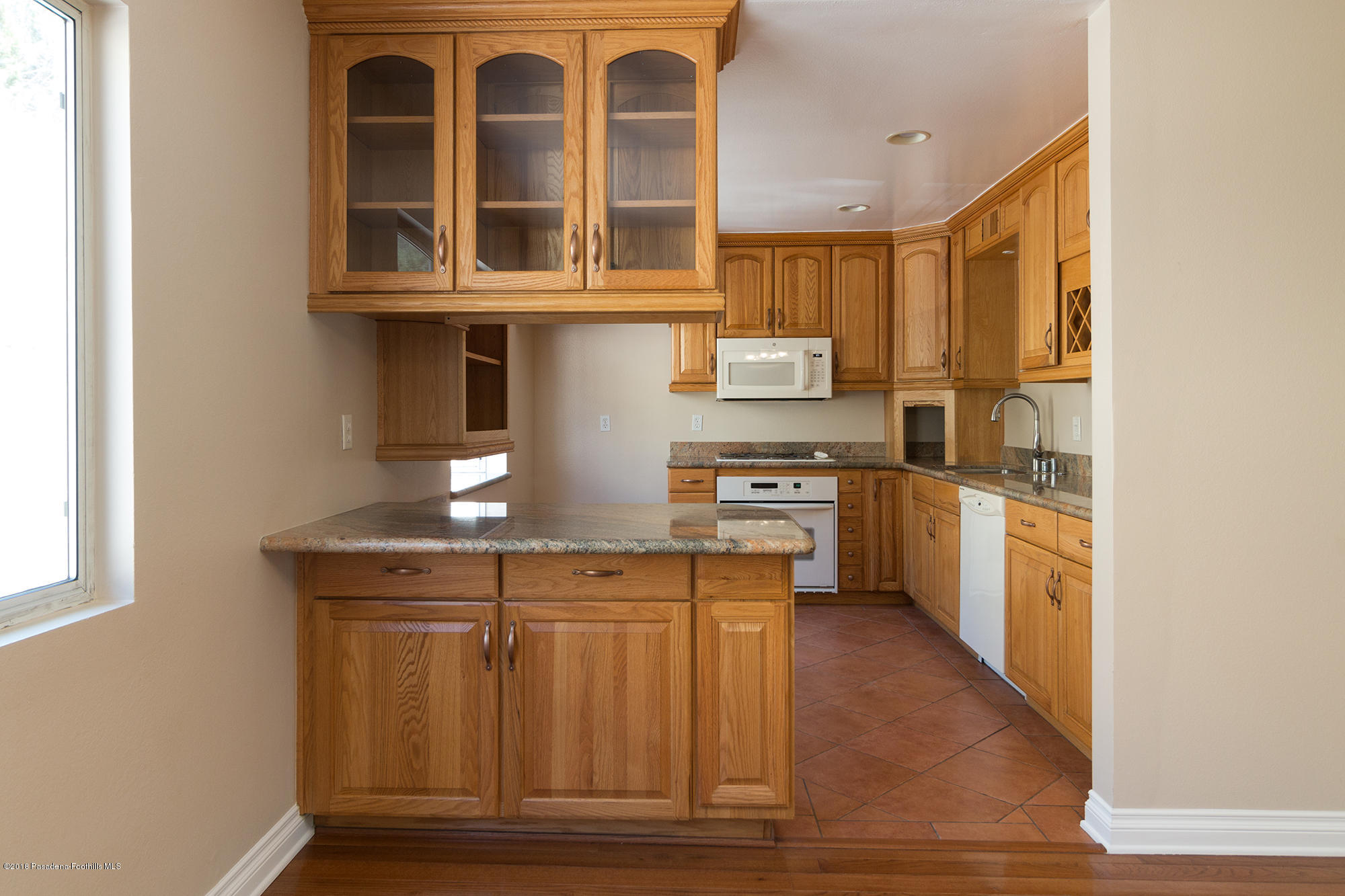 9730 Vía Roma Burbank, CA 91504 - Photo 10 of 24 a kitchen with stainless steel appliances granite countertop a stove a sink and a microwave