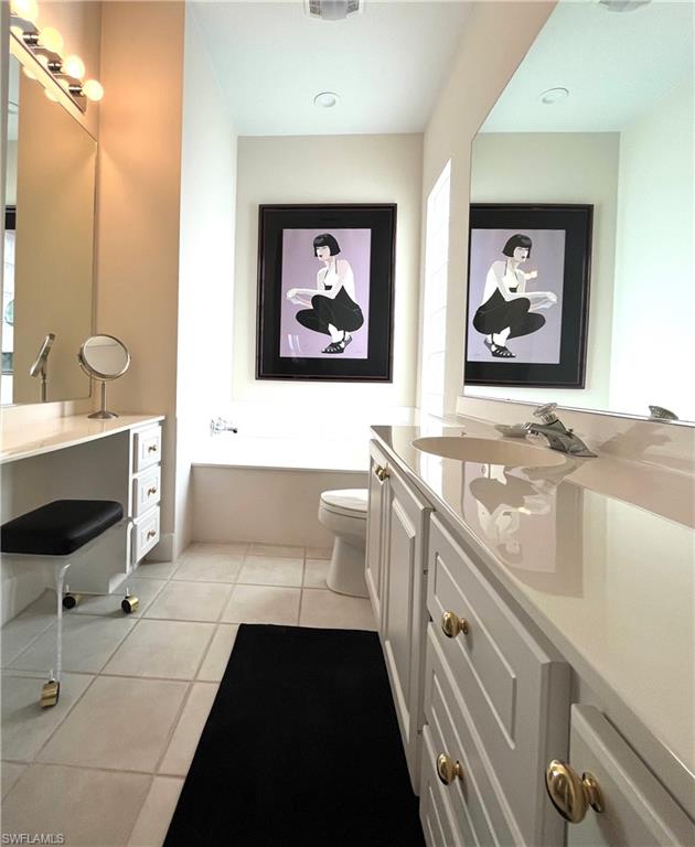 5477 Freeport Lane Naples, FL 34119 - Photo 15 of 36 a spacious bathroom with a bathtub and a double vanity sink