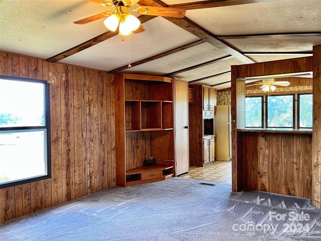 7001 Alexander Farm Road Monroe, NC 28110 - Photo 4 of 14 an empty room with wooden floor staircase and windows