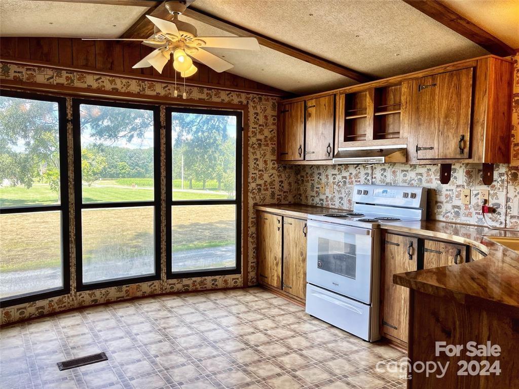 7001 Alexander Farm Road Monroe, NC 28110 - Photo 5 of 14 a kitchen with stainless steel appliances granite countertop a stove a sink and a microwave