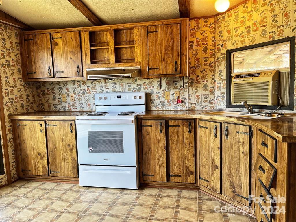7001 Alexander Farm Road Monroe, NC 28110 - Photo 7 of 14 a kitchen with stainless steel appliances granite countertop a stove a sink and a microwave