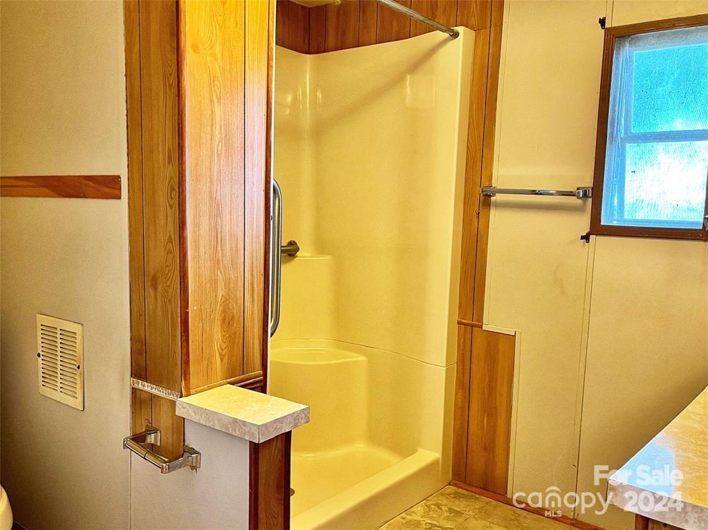 7001 Alexander Farm Road Monroe, NC 28110 - Photo 9 of 14 a bathroom with a window and a shower