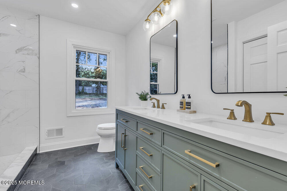 8 Holling Road Colts Neck, NJ 07722 - Photo 11 of 41 a bathroom with a double vanity sink toilet and shower