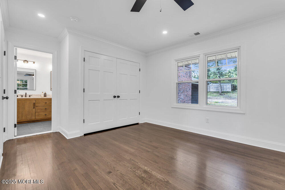 8 Holling Road Colts Neck, NJ 07722 - Photo 20 of 41 a view of a livingroom with wooden floor and windows