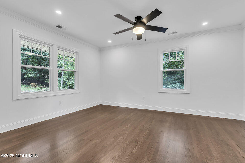 8 Holling Road Colts Neck, NJ 07722 - Photo 21 of 41 an empty room with wooden floor and windows