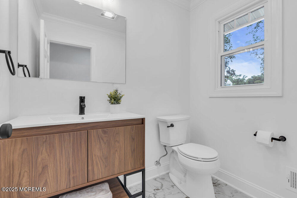 8 Holling Road Colts Neck, NJ 07722 - Photo 24 of 41 a bathroom with a toilet a sink and mirror