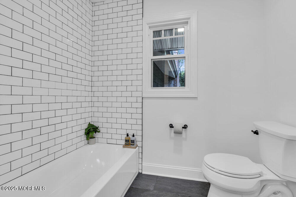 8 Holling Road Colts Neck, NJ 07722 - Photo 28 of 41 a bathroom with a bathtub and toilet