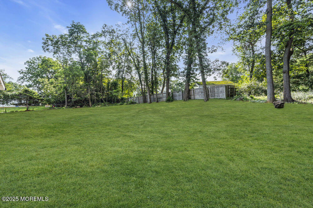 8 Holling Road Colts Neck, NJ 07722 - Photo 36 of 41 a view of a grassy field with trees in the background