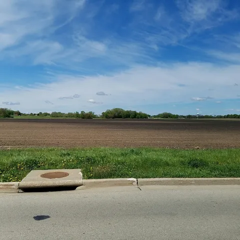 a view of a lake with couches in the backyard