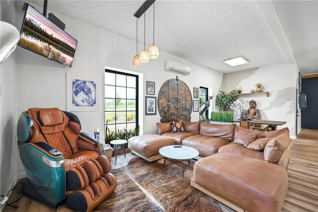 a living room with furniture a flat screen tv and a fireplace