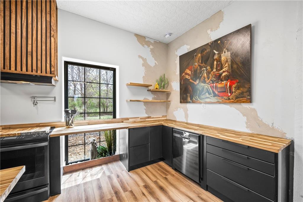 356 West Oak Grove Road Northwest Adairsville, GA 30103 - Photo 21 of 128 a kitchen with stainless steel appliances granite countertop a stove and a sink
