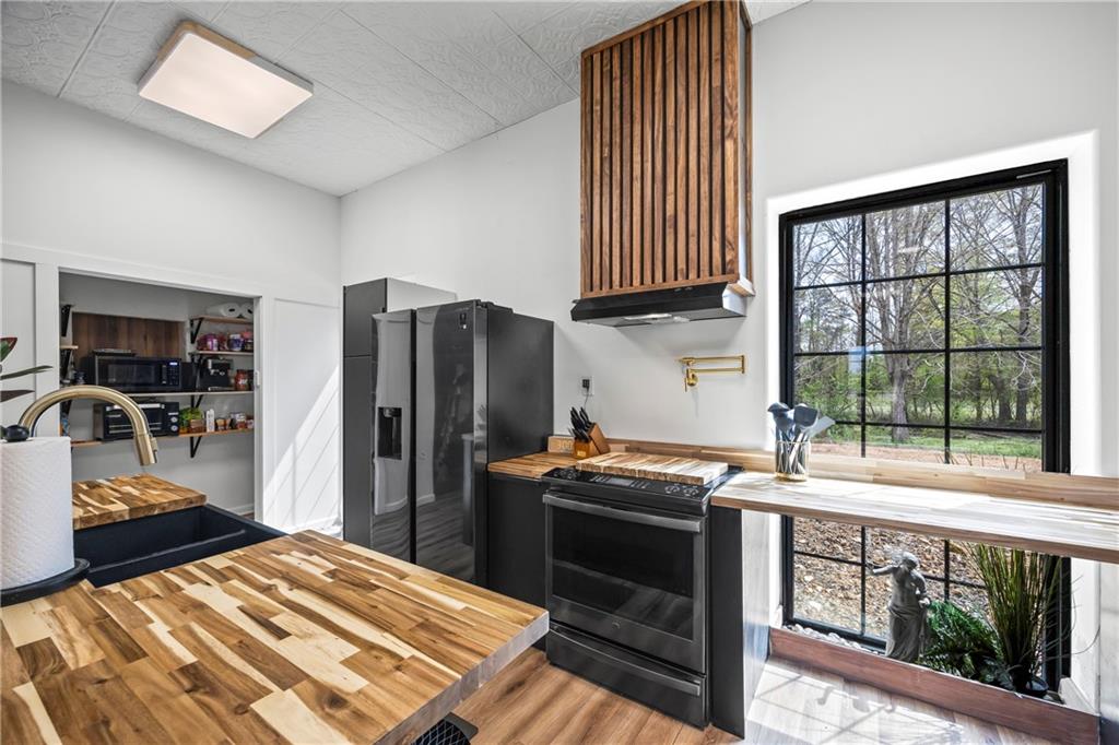 356 West Oak Grove Road Northwest Adairsville, GA 30103 - Photo 26 of 128 a kitchen with stainless steel appliances a stove a sink and a refrigerator
