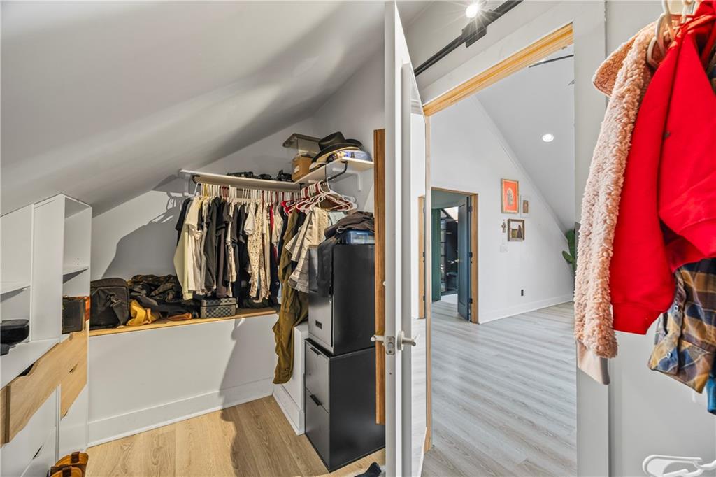 356 West Oak Grove Road Northwest Adairsville, GA 30103 - Photo 40 of 128 a view of walk in closet with clothes and shoes