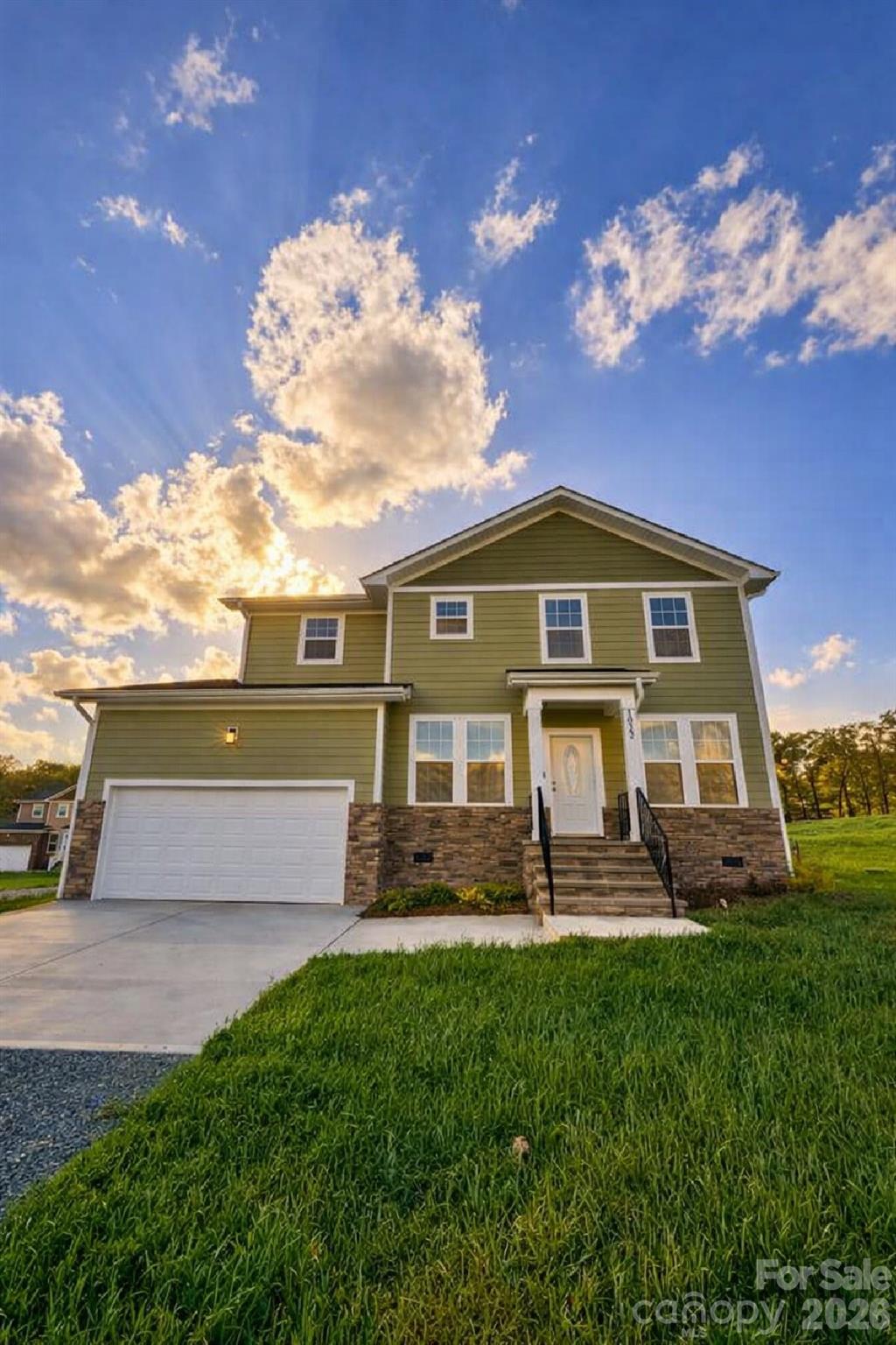 a front view of a house with garden