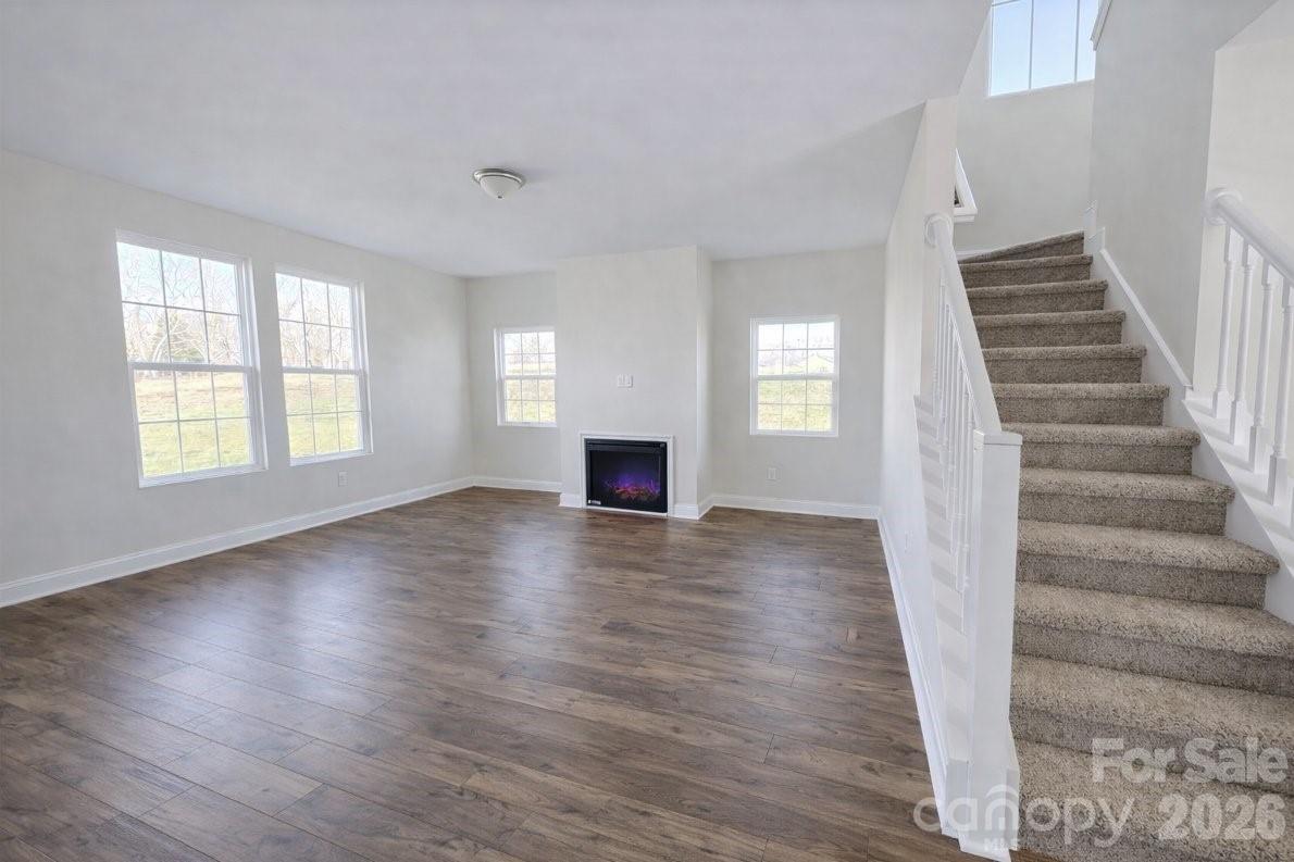 1022 Heath Helms Road Monroe, NC 28110 - Photo 2 of 10 a view of an empty room with wooden floor and a window