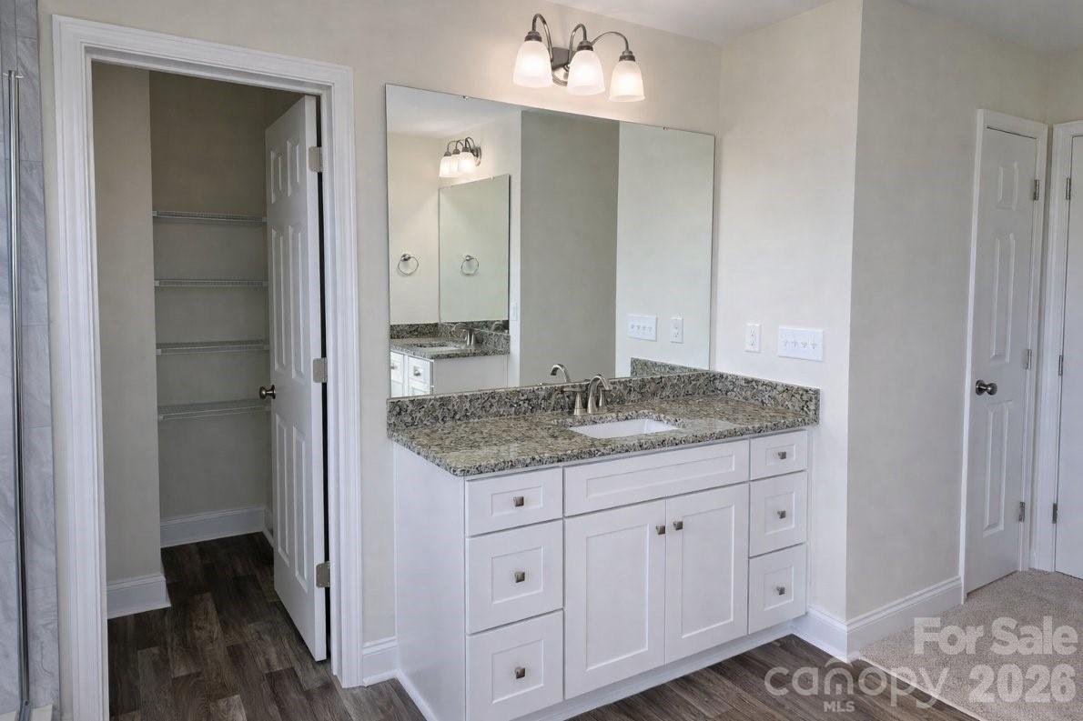 1022 Heath Helms Road Monroe, NC 28110 - Photo 5 of 10 a bathroom with a granite countertop sink and a mirror