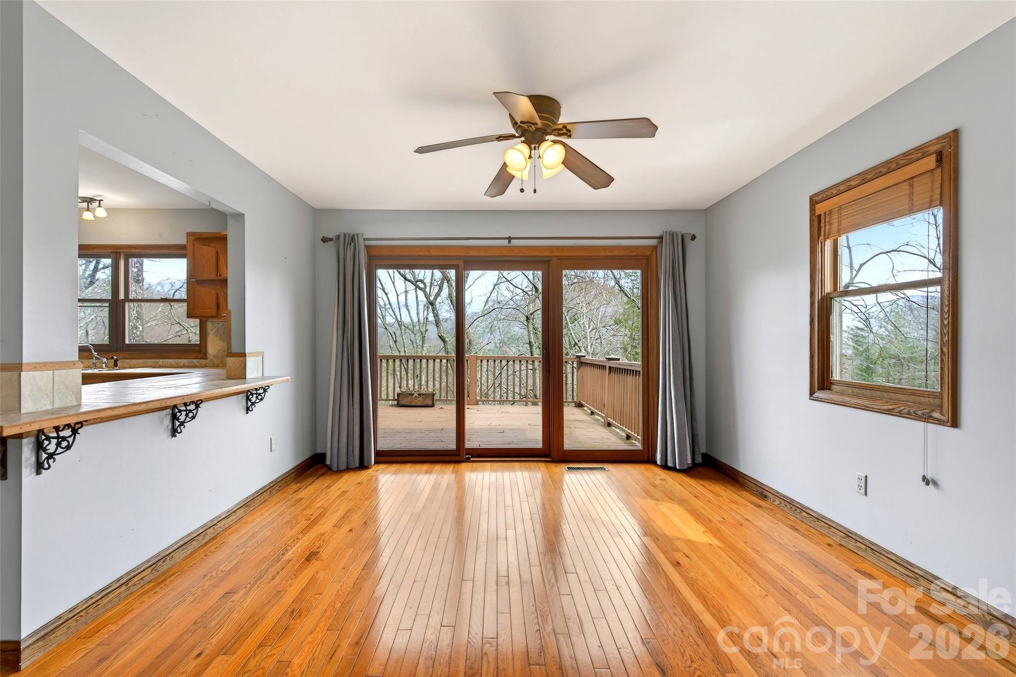 169 Hilltop Road Black Mountain, NC 28711 - Photo 13 of 48 a view of an empty room with a window and wooden floor