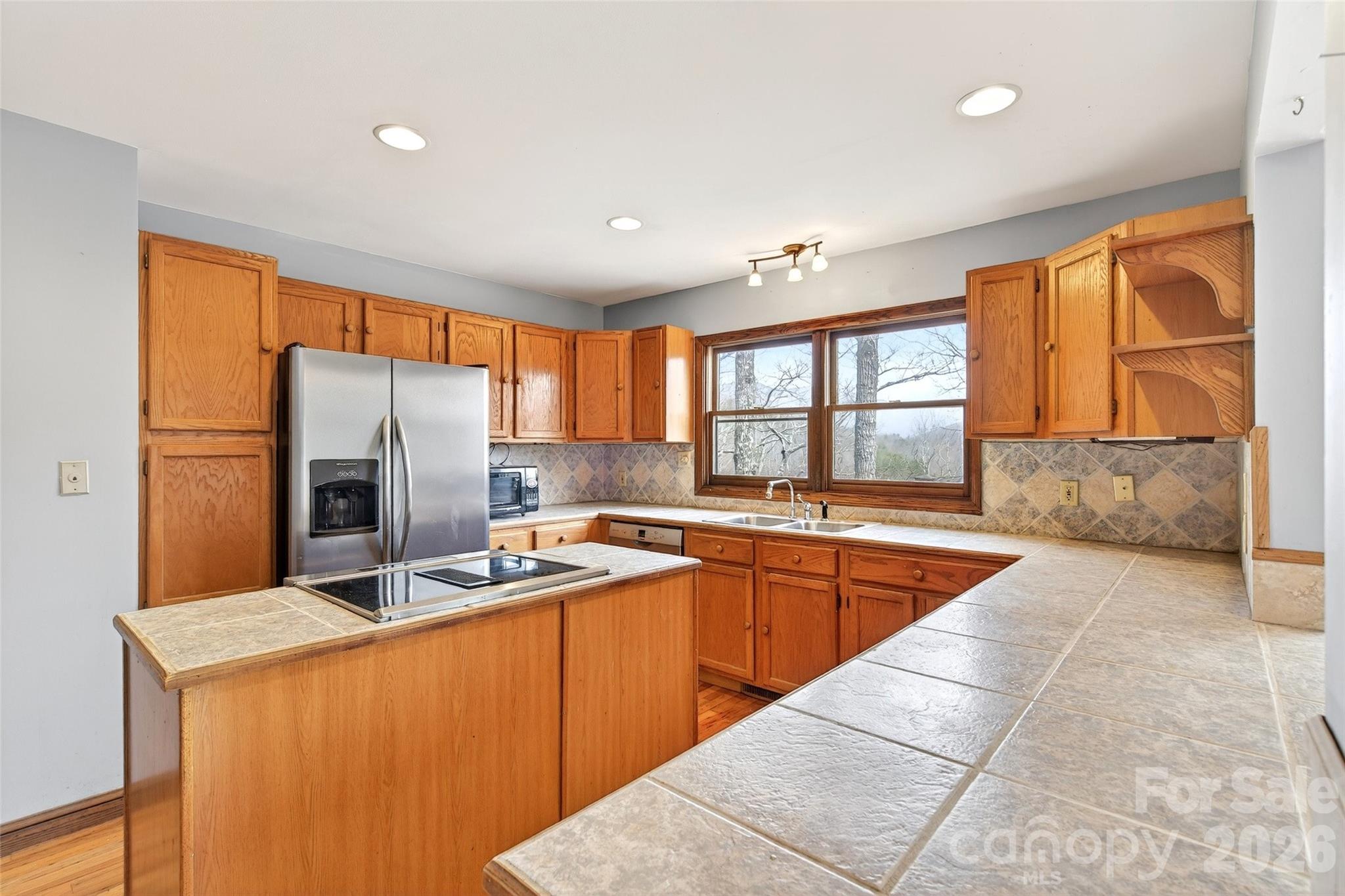 169 Hilltop Road Black Mountain, NC 28711 - Photo 18 of 48 a large kitchen with stainless steel appliances granite countertop a sink and a stove