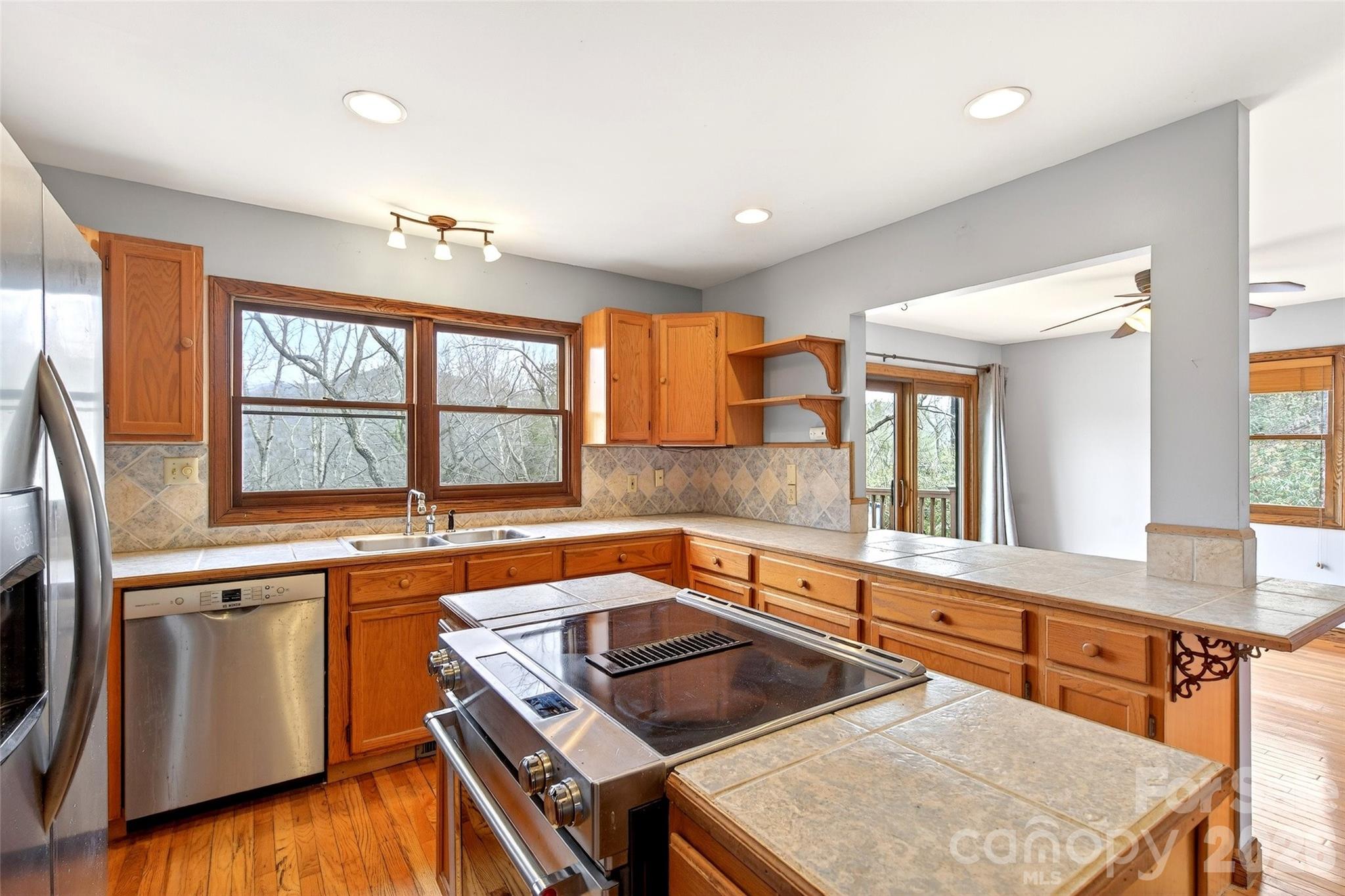 169 Hilltop Road Black Mountain, NC 28711 - Photo 19 of 48 a kitchen that has a sink a stove and wooden floor
