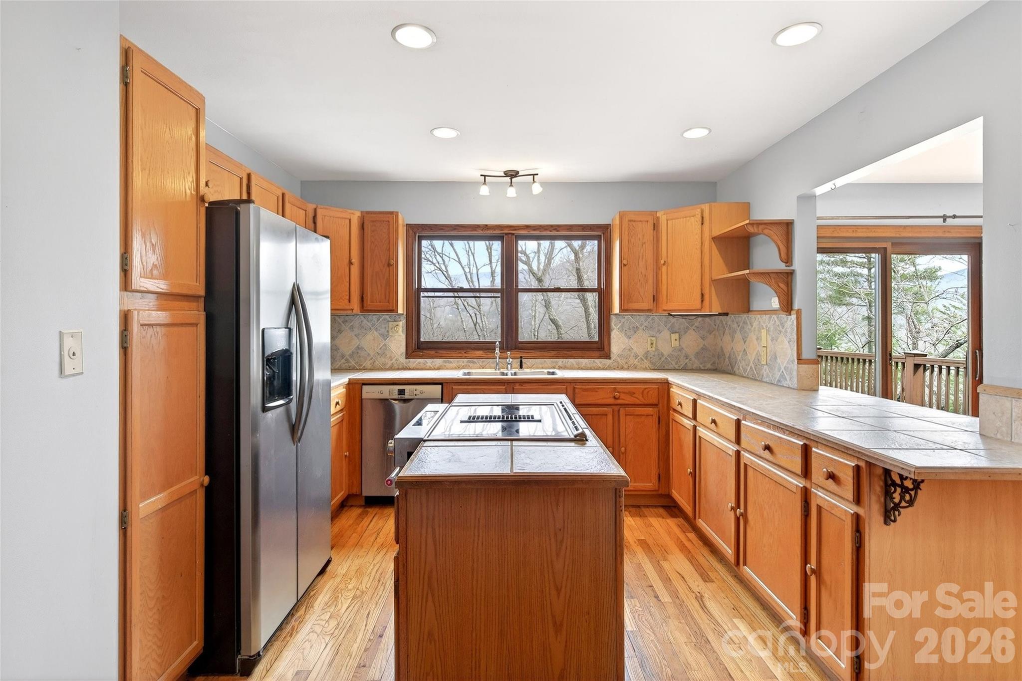 169 Hilltop Road Black Mountain, NC 28711 - Photo 21 of 48 a kitchen with stainless steel appliances granite countertop a refrigerator and a sink