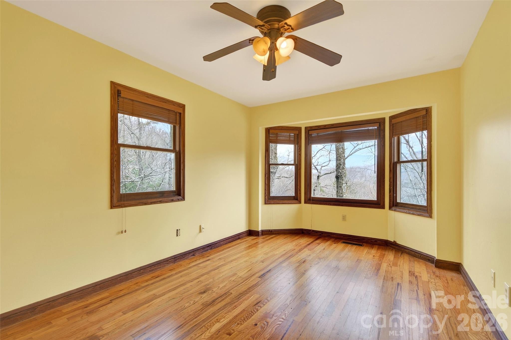 169 Hilltop Road Black Mountain, NC 28711 - Photo 26 of 48 a view of an empty room with wooden floor and a window