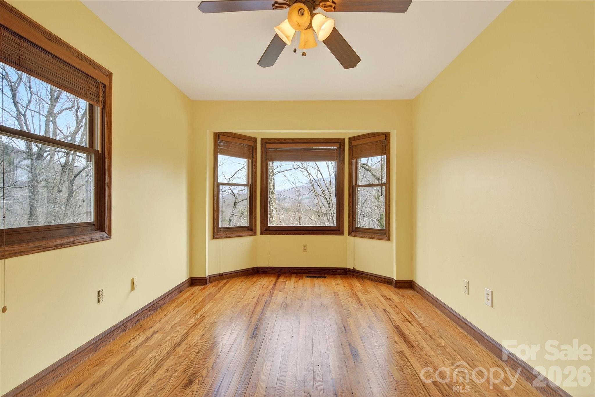 169 Hilltop Road Black Mountain, NC 28711 - Photo 27 of 48 a view of empty room with wooden floor and fan