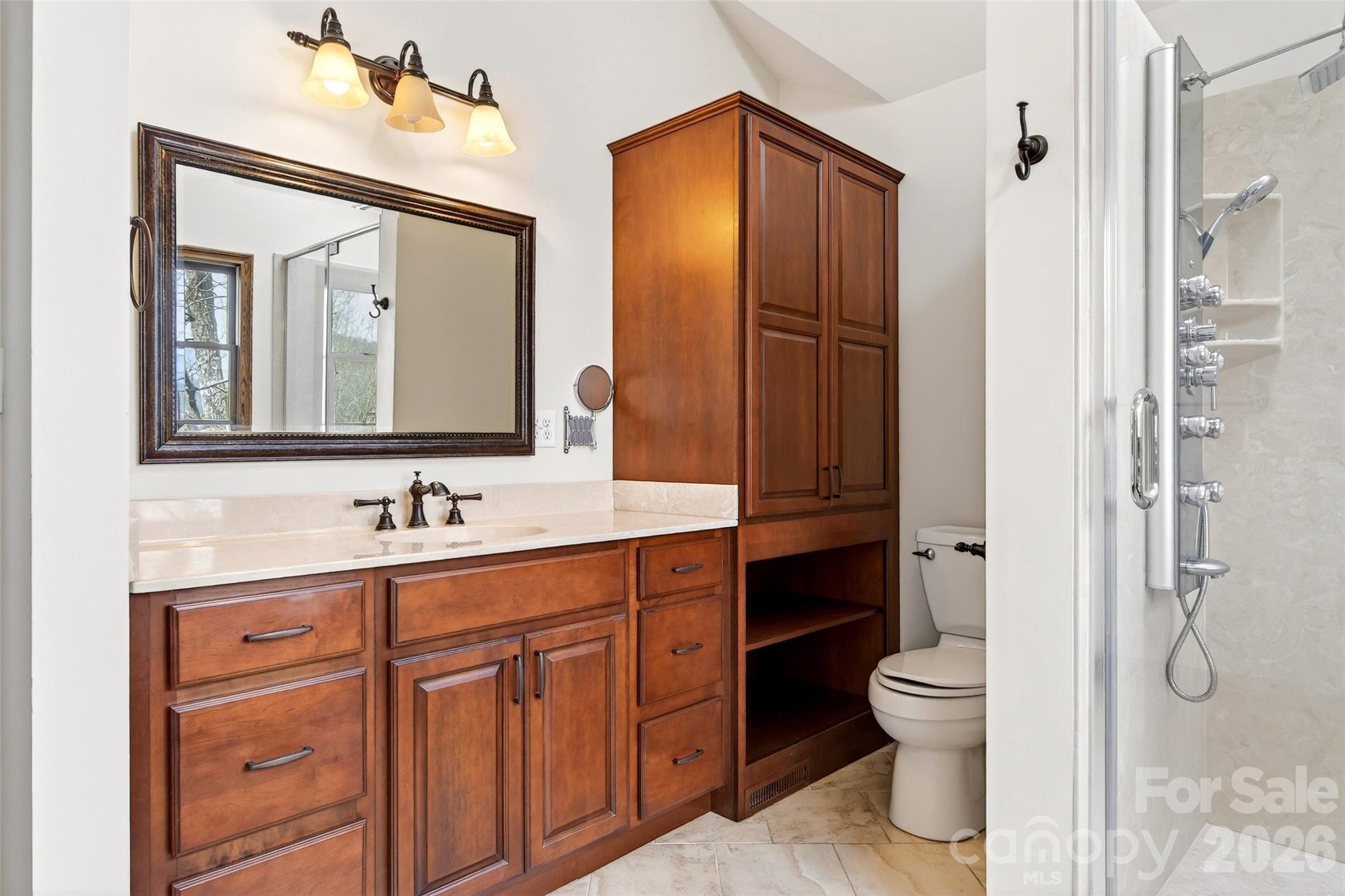 169 Hilltop Road Black Mountain, NC 28711 - Photo 32 of 48 a bathroom with a toilet sink shower and mirror