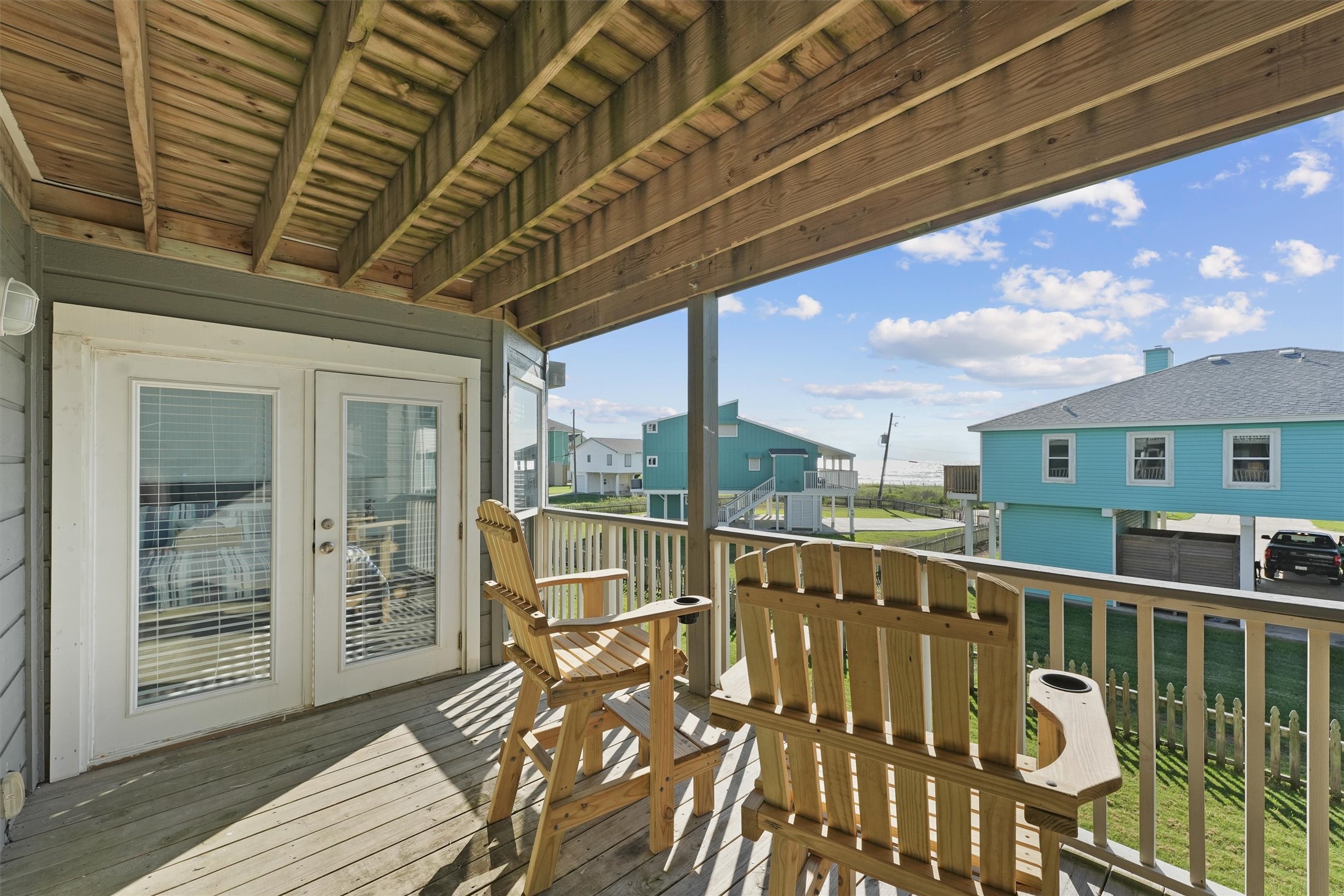 17607 Termini-San Luis Pass Road Galveston, TX 77554 - Photo 23 of 42 Step out onto the second balcony directly from either bedroom to unwind and take in the views. The charming wooden deck and comfortable seating make it an ideal spot to relax and enjoy the surroundings.