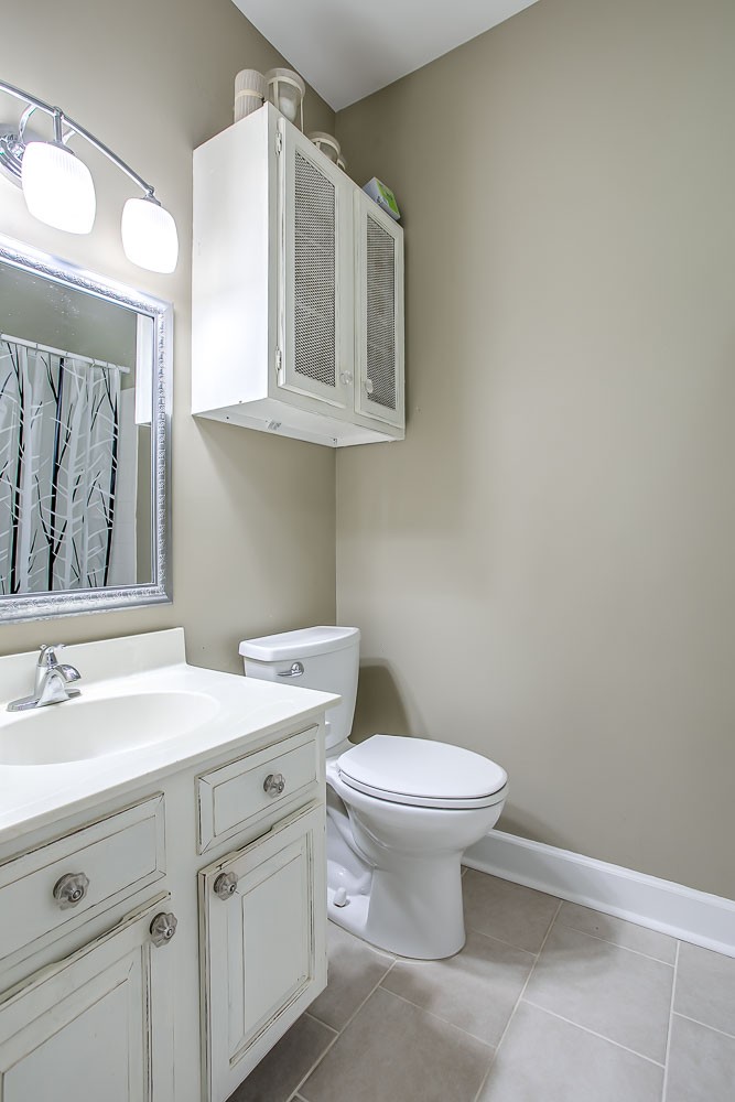1129 West Main Street, Unit 1 Franklin, TN 37064 - Photo 17 of 30 a bathroom with a sink a toilet and mirror