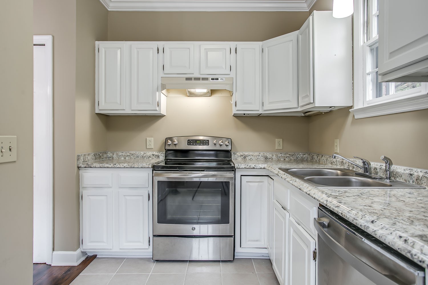 1129 West Main Street, Unit 1 Franklin, TN 37064 - Photo 10 of 30 a kitchen with granite countertop white cabinets and a stove