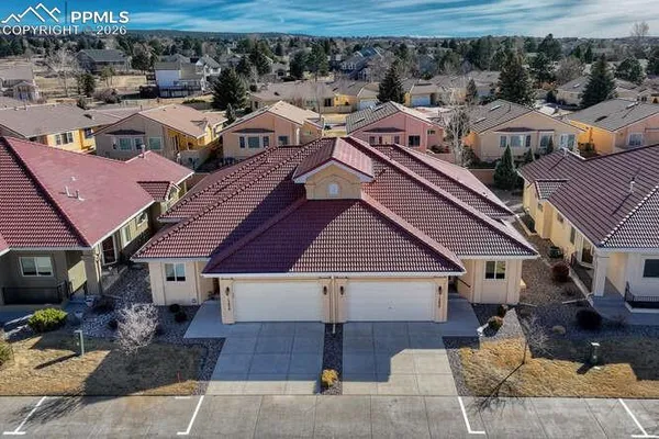 an aerial view of a house with a yard