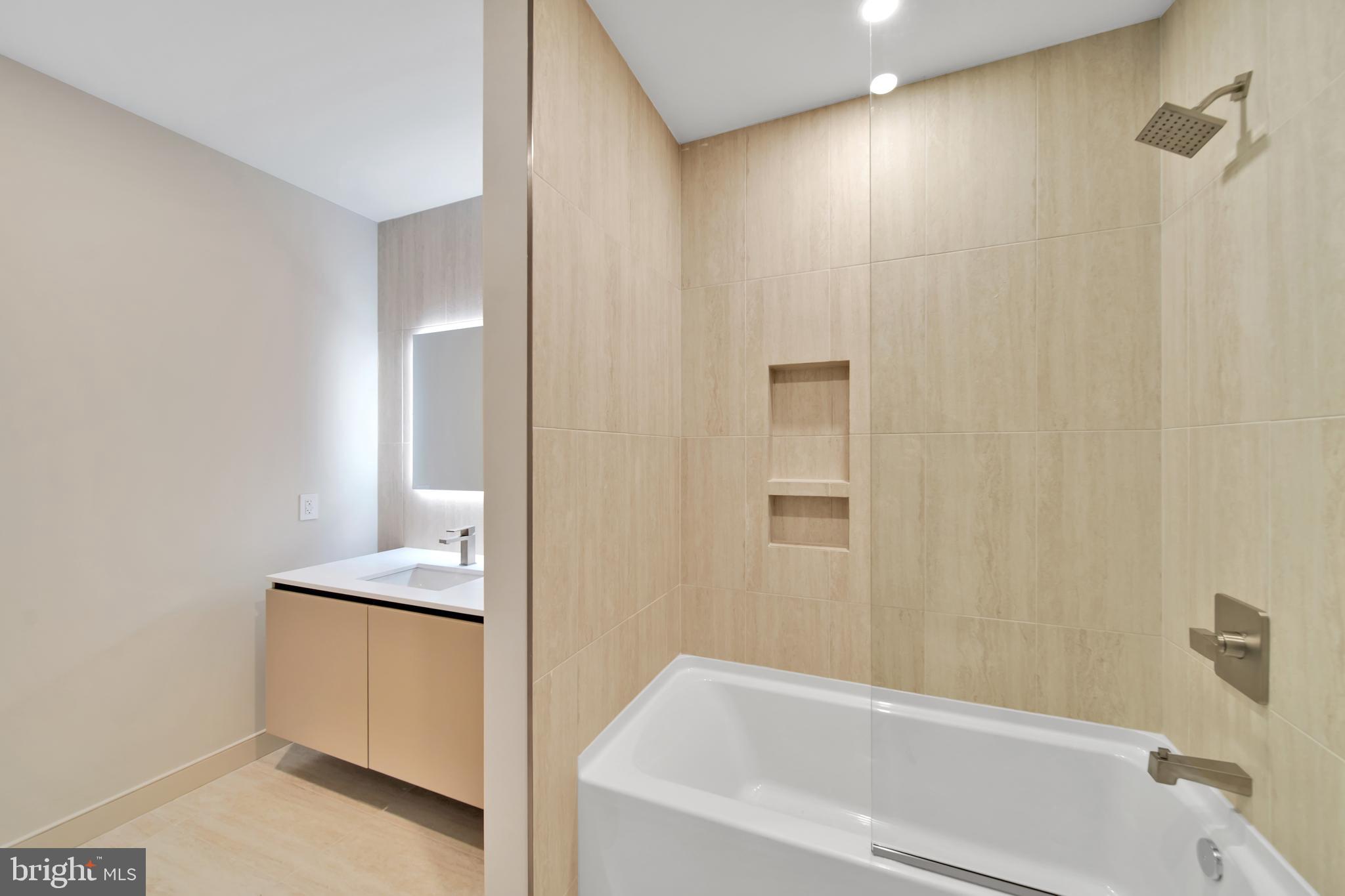 2121 Ward Place Northwest, Unit 405 Washington, DC 20037 - Photo 11 of 18 a bathroom with a bathtub and shower