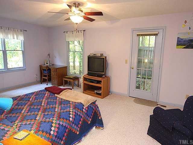 11717 Old Creedmoor Road Raleigh, NC 27613 - Photo 8 of 12 a bedroom with a bed and furniture